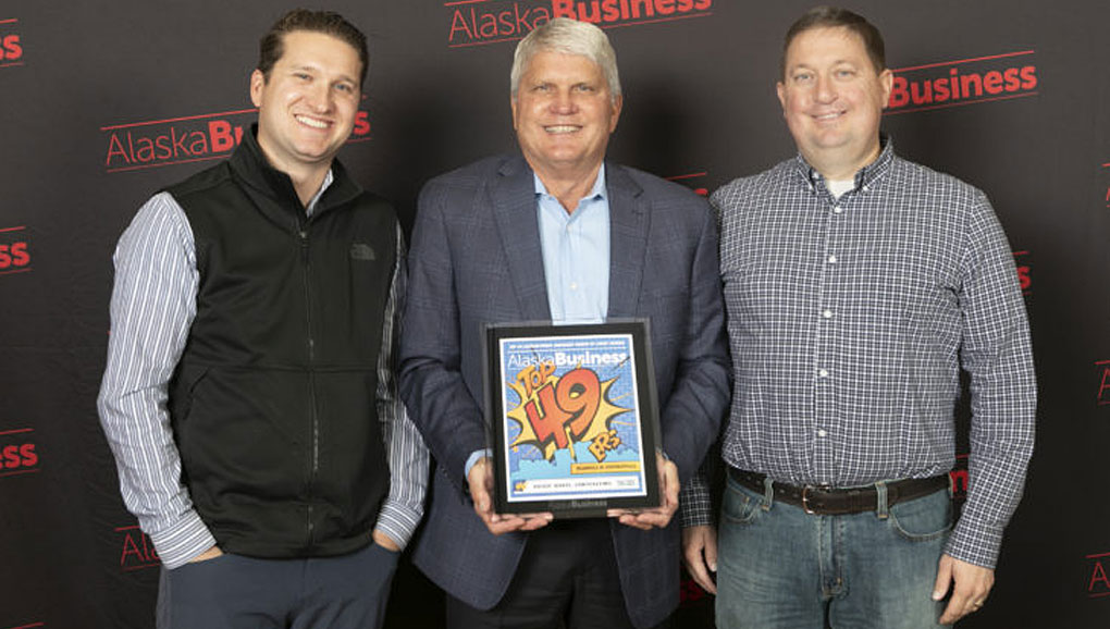 3 people holding award